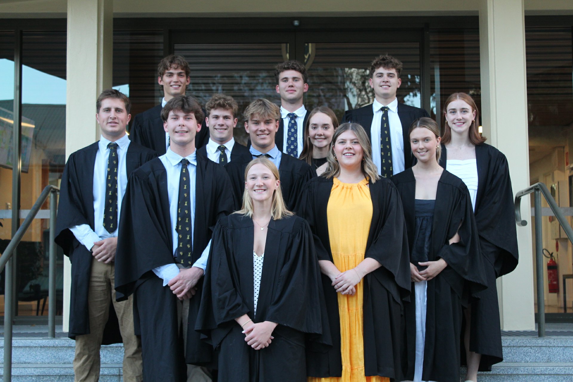 Student Club Executive in Academic Gowns in Courtyard