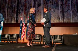 Gayan in parliament receiving a Fulbright from Ambassador Caroline Kennedy