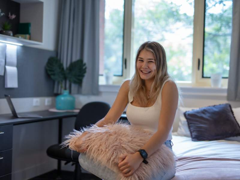 Student enjoying St John's College accommodation at the University of Queensland