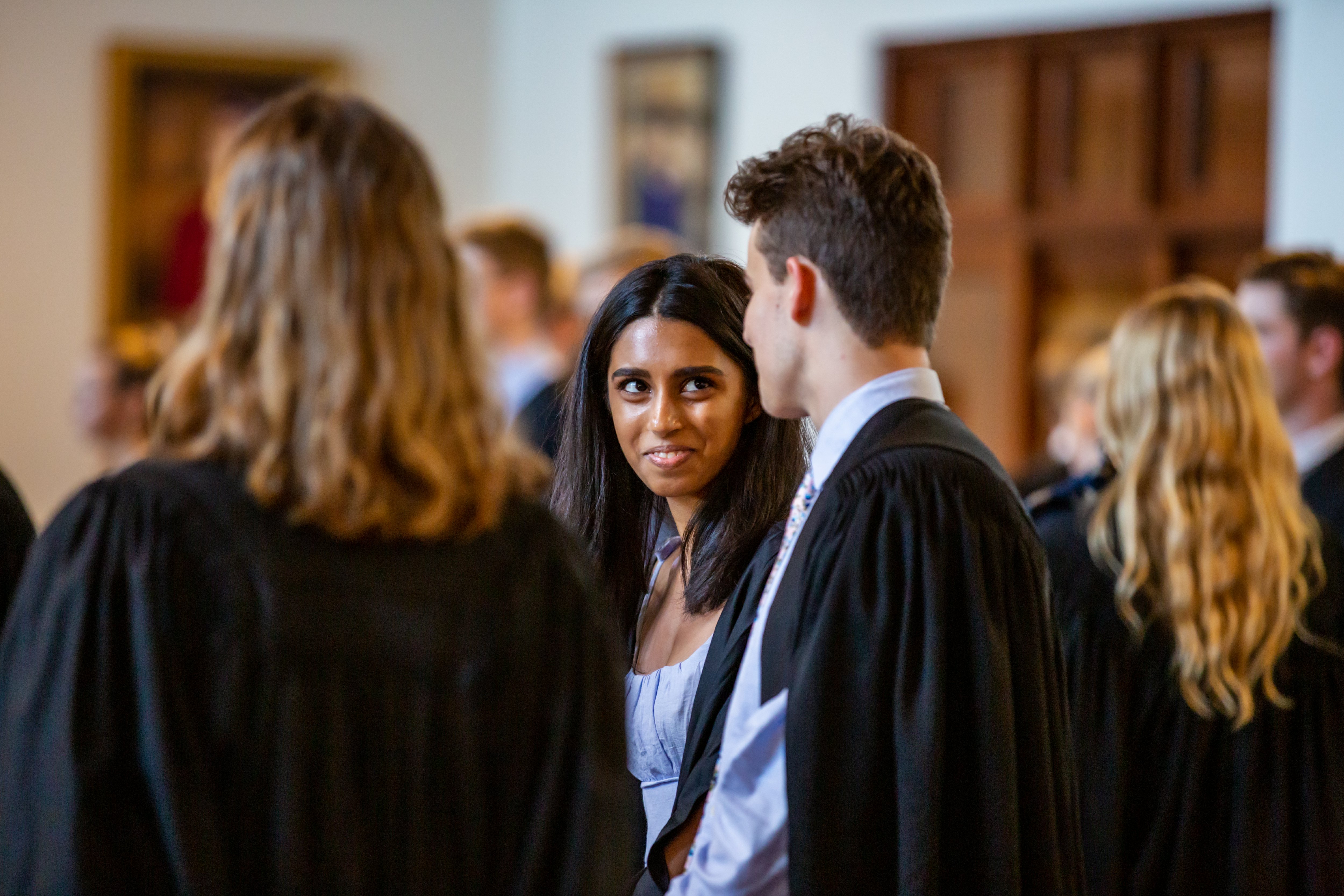 Students in robes at a St John's College formal dinner