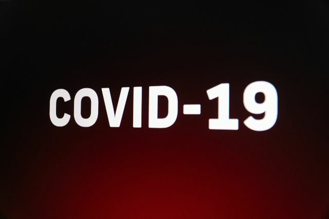 Graphic of the words COVID-19 on a dramatic background