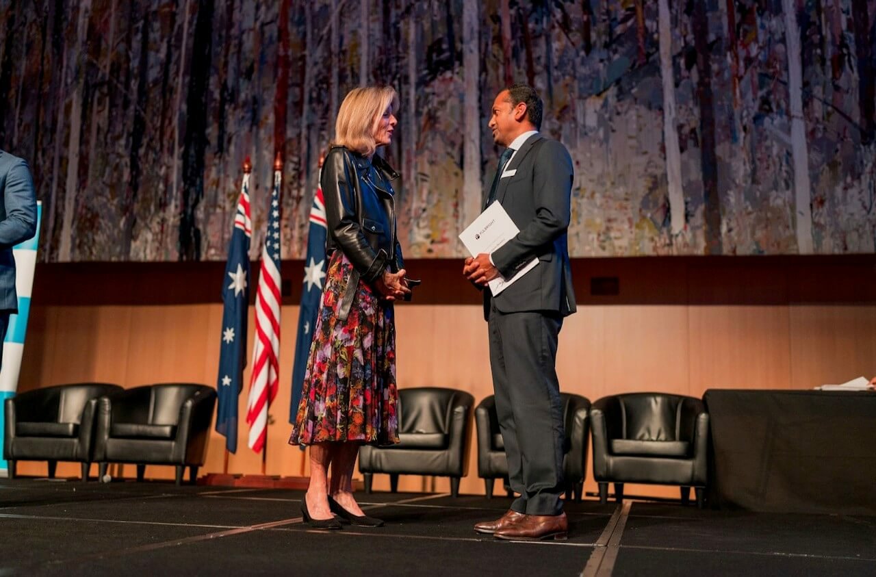 Gayan in parliament receiving a Fulbright from Ambassador Caroline Kennedy