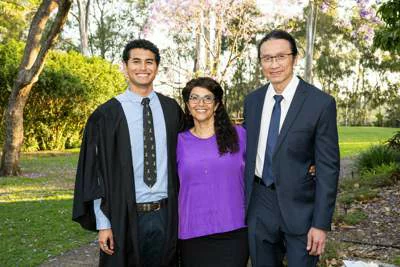 St John's Foundation donors Helen and Chen Wu with their son in the St John's grounds on a sunny day